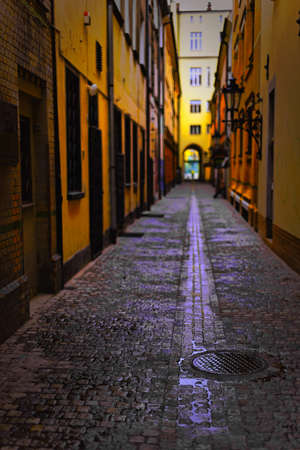 Narrow, wet cobbled street の写真素材