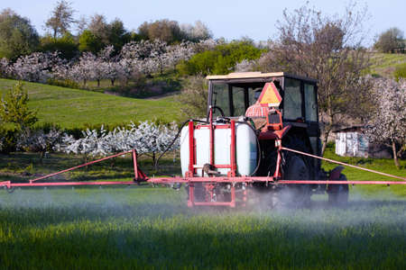 Tractor spraying on the fieldの写真素材