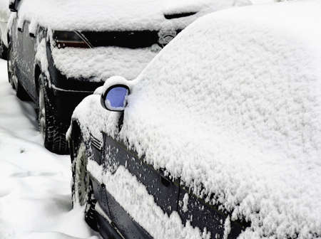Snow covered cars on streetの写真素材