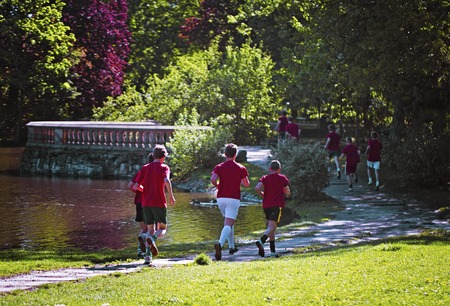 Young boys run in the parkの写真素材