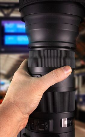 Holding big zoom lens in hand