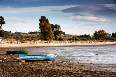 Dried lake with some boats on beachの写真素材