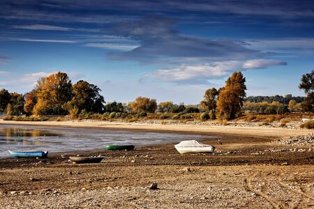 Dried lake with some boats on beachの写真素材