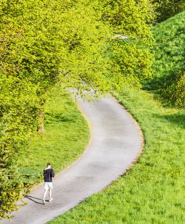 Young man running in the morning in public parkの写真素材