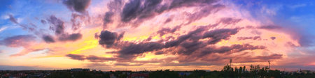 Dramatic sunset like fire in the sky with golden cloudsの写真素材