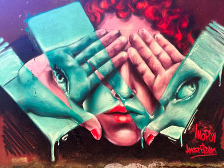 WROCLAW, POLAND-AUGUST 30, 2016: Colorful graffiti in downtown depicts human facesのeditorial素材