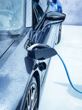 Electric vehicle being plugged inの写真素材