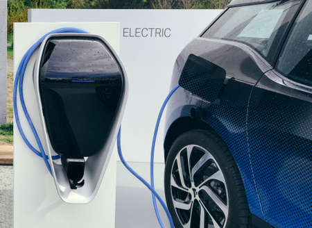 Electric vehicle being plugged inの写真素材