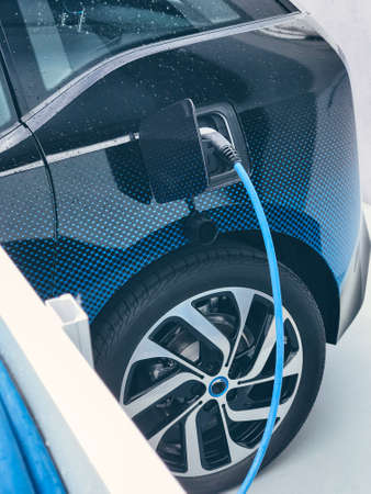 Electric vehicle being plugged inの写真素材