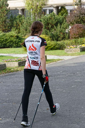 WROCLAW, POLAND - OCTOBER 15, 2017: People in fitness course nordic walking competition in the city parkのeditorial素材