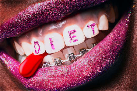 Sexy lipstick on a young woman mouthの写真素材