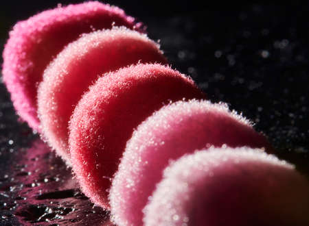 Fluffy and colorful litle balls on black background