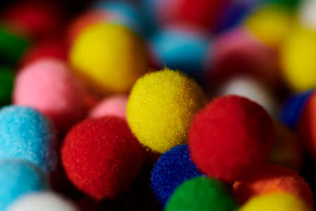 Fluffy and colorful litle balls on black backgroundの写真素材