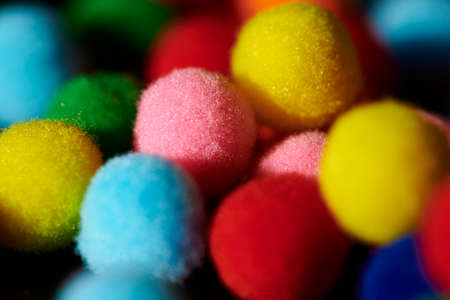 Fluffy and colorful litle balls on black backgroundの写真素材