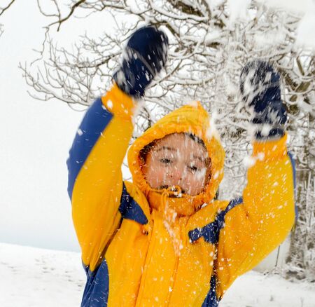Cute little boy playing in the snow