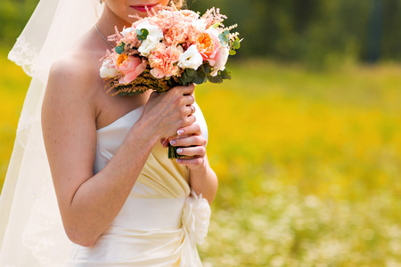 Bride Holding Wedding Bouquet with beautiful Flowersの写真素材