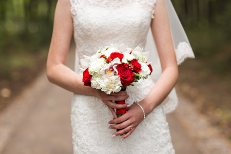 Bride Holding Wedding Bouquet with beautiful Flowersの写真素材