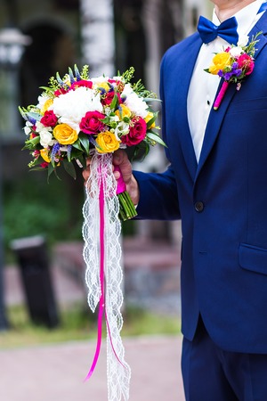 Groom is holding a beautiful  bridal bouquetの写真素材