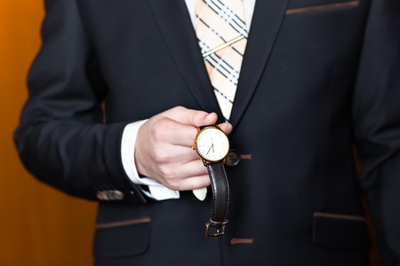 business man  looking at watch over white backgroundの写真素材