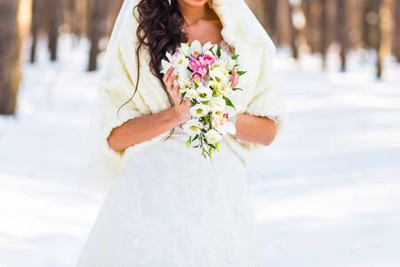 Beautiful wedding bouquet in hands of the brideの写真素材