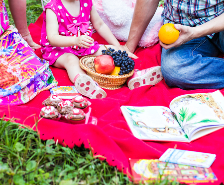 Family  picnicking together, father, mother and daughterの写真素材