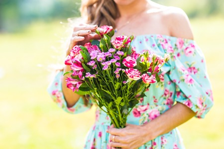 beautiful  young girl with a bouquet of flowersの写真素材