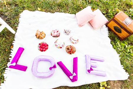 Happy Couple Having Romantic Picnic Together Outsideの写真素材