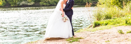 Beautiful Wedding couple holding hands and huggingの写真素材
