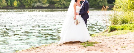 Beautiful Wedding couple holding hands and huggingの写真素材