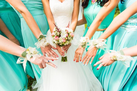 bride and bridesmaids dressed in a blue dressの写真素材