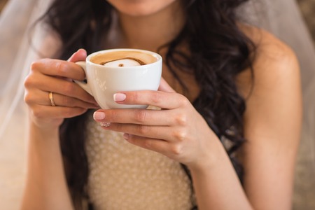 coffee cup in hands of young womanの写真素材