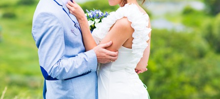 Wedding couple of bride and groom near the river