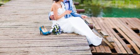 Wedding couple of bride and groom near the riverの写真素材