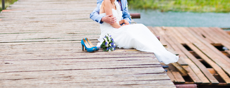 Wedding couple of bride and groom near the riverの写真素材