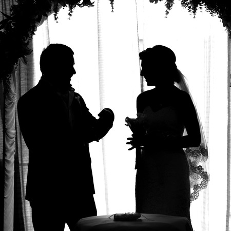 silhouette of the bride and groom at a wedding.の写真素材