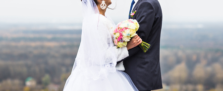 bride and groom walking together in the parkの写真素材