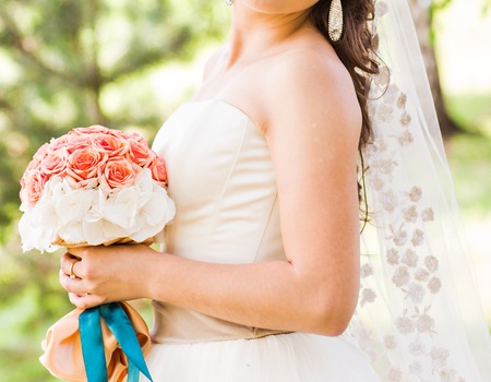 Beautiful wedding bouquet of flowers in hands of the brideの写真素材