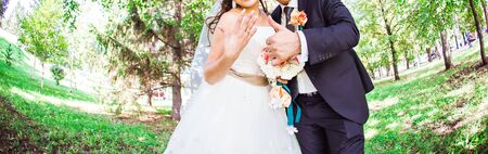 Bride and groom with flower thumb up outdoor.の写真素材