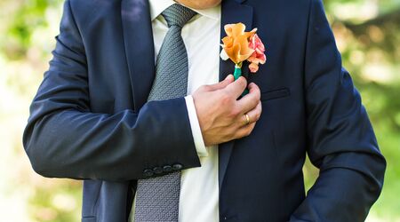 Handsome groom at wedding waiting for bride. Elegant groom in costume.