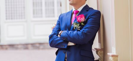 Handsome groom at wedding waiting for bride. Elegant groom in costume.の写真素材