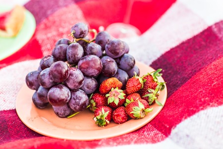 Basket of fresh straw and fresh grapesの写真素材