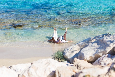 Bride and groom by the sea on their wedding dayの写真素材