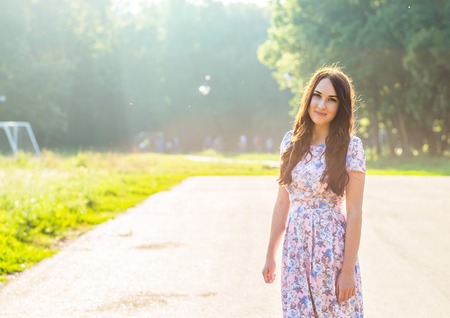 beautiful young brunette woman  on the  park  on a warm summer dayの写真素材