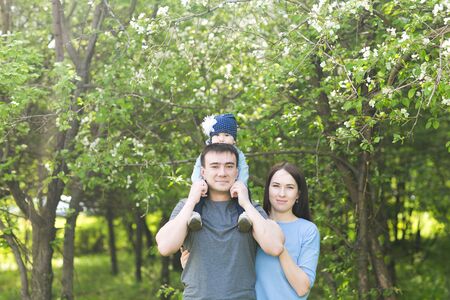 Happy young family spending time together in green nature.の写真素材