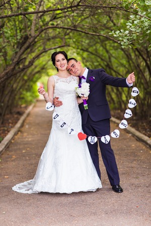 Beautiful wedding couple with just married wordsの写真素材