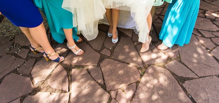 feet  in shoes  of a bride and her bridesmaidsの写真素材