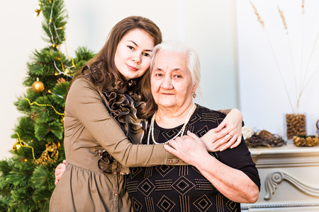 grandmother and daughter at christmas at home in the living roomの写真素材