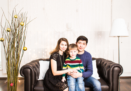 Portrait of friendly family looking at camera on Christmas eveの写真素材