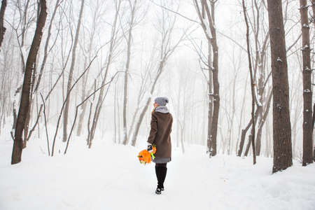 Attractive young woman in wintertime outdoor. Christmas time