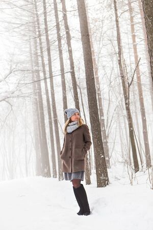 Attractive young woman in wintertime outdoor. Christmas timeの写真素材